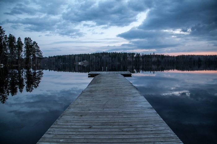 Wooden dock on a lake at dusk in Finland