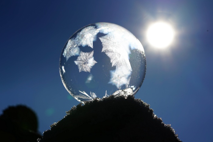 Frozen Soap Bubble with Ice Crystals in Sunlight