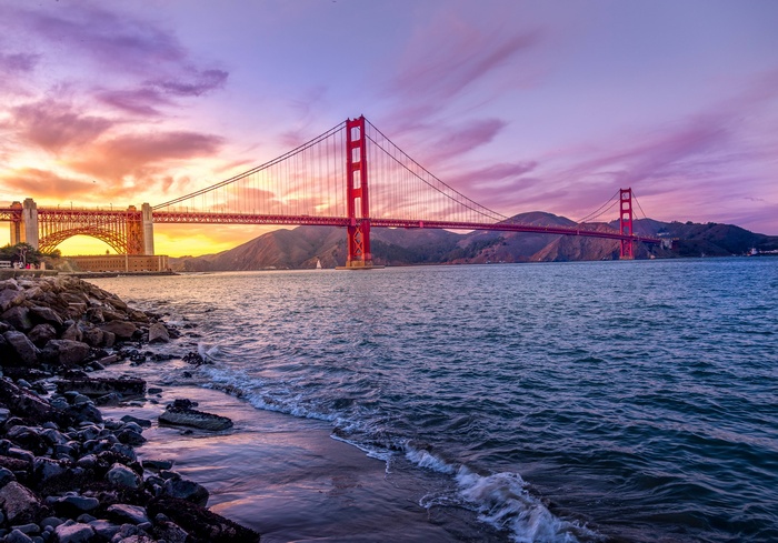 Golden Gate Bridge at sunset with purple sky