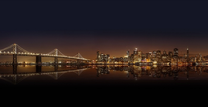 San Francisco Bay Bridge and skyline at night