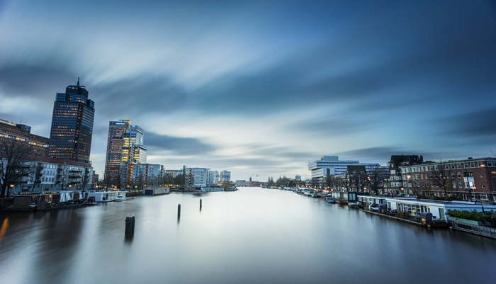 Cityscape with river and buildings at dusk