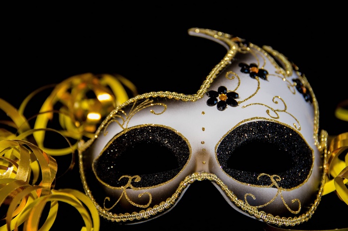 White and gold masquerade mask with black glitter