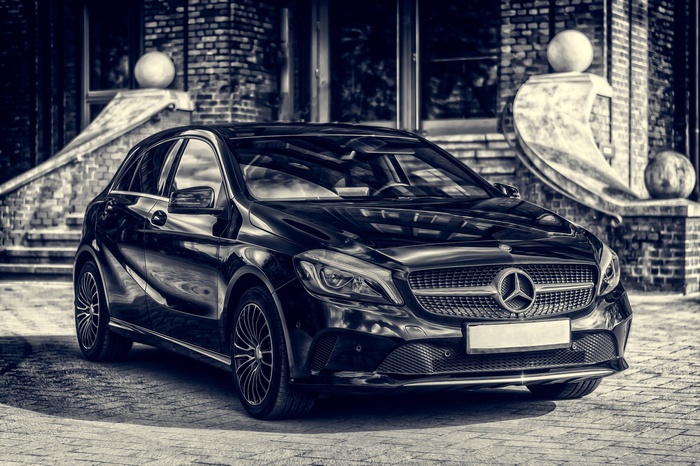 Black Mercedes-Benz A-Class parked in front of a building