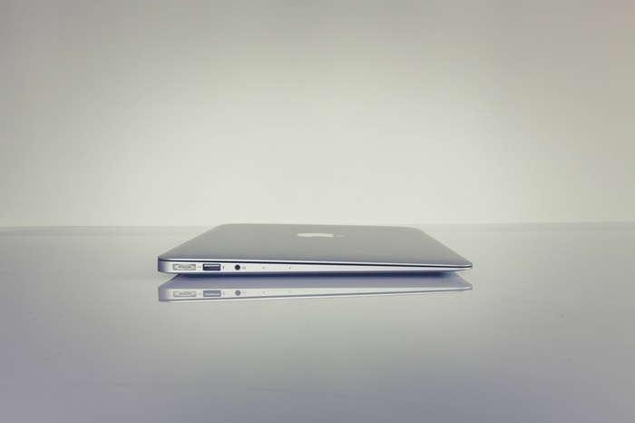 Silver Apple MacBook laptop on a reflective surface