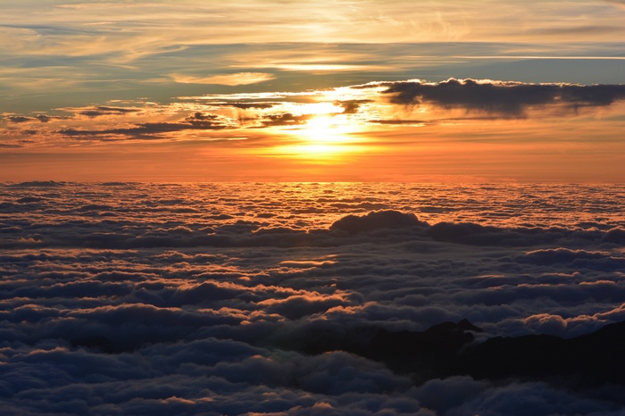 Sunset above clouds at twilight