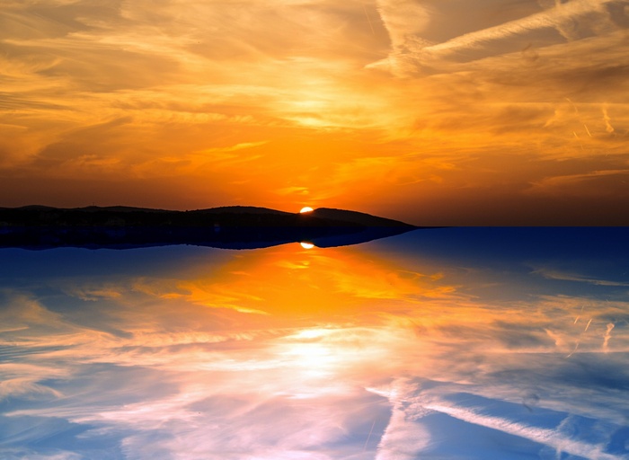 Sunset over the sea with reflection
