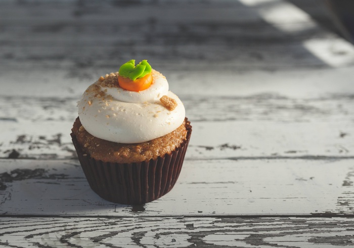 Carrot cupcake with cream cheese frosting and carrot decoration