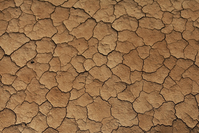 Cracked dry earth texture in brown and beige