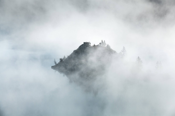 Island in the clouds and fog
