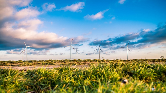 Wind farm with turbines under a cloudy sky