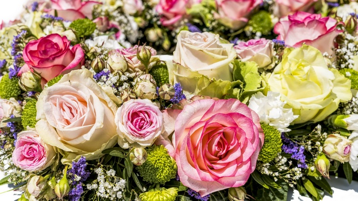 A close-up of a colorful bouquet of roses and other flowers.