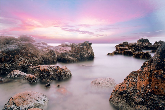 Rocky beach with pastel sky at sunset