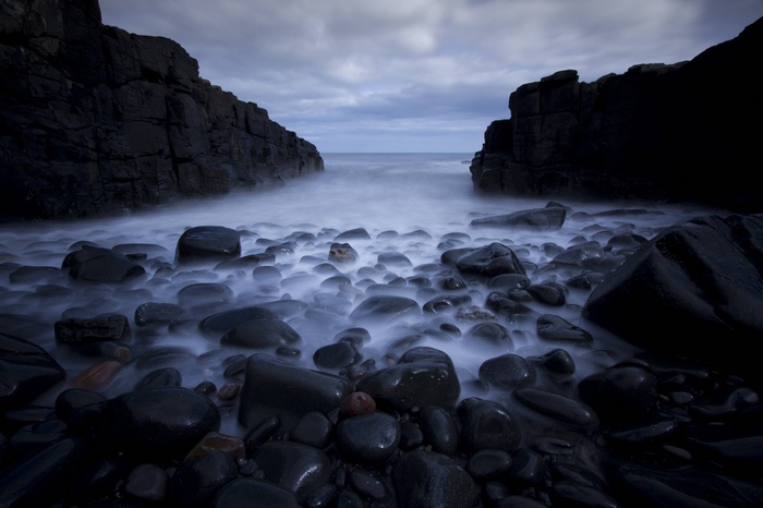 Long exposure of ocean waves crashing on a rocky beach
