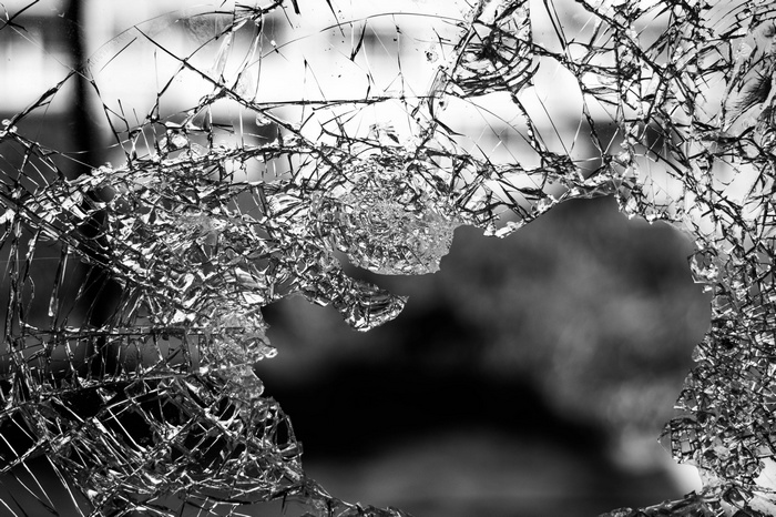 Shattered glass window with a large hole