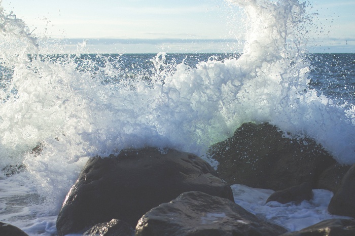 Wave crashing on rocks at the shore