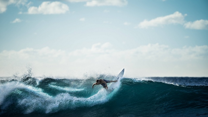 Surfer riding a wave in the ocean