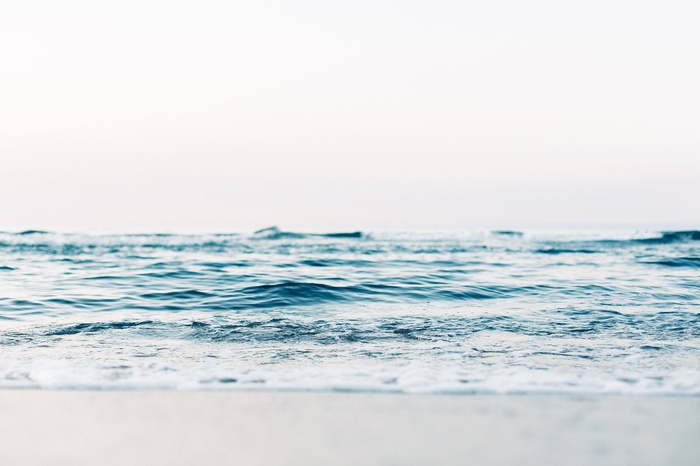 Ocean waves rolling onto a sandy beach