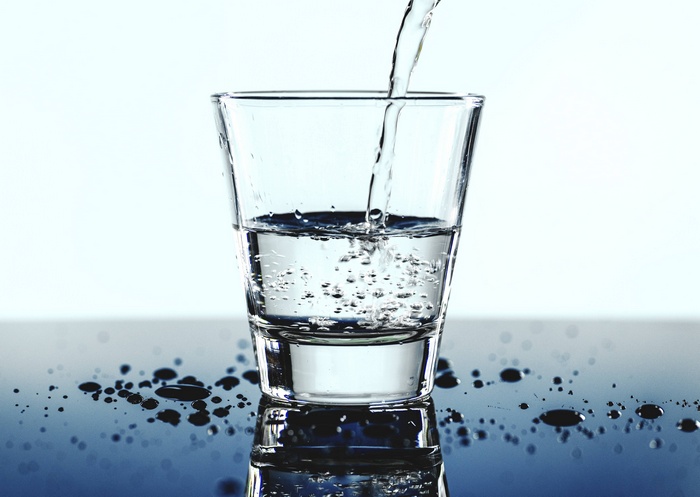 Water being poured into a clear glass