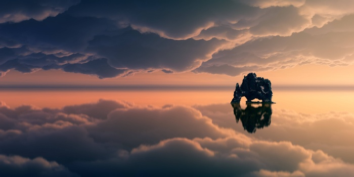 Rock formation in the ocean at sunset