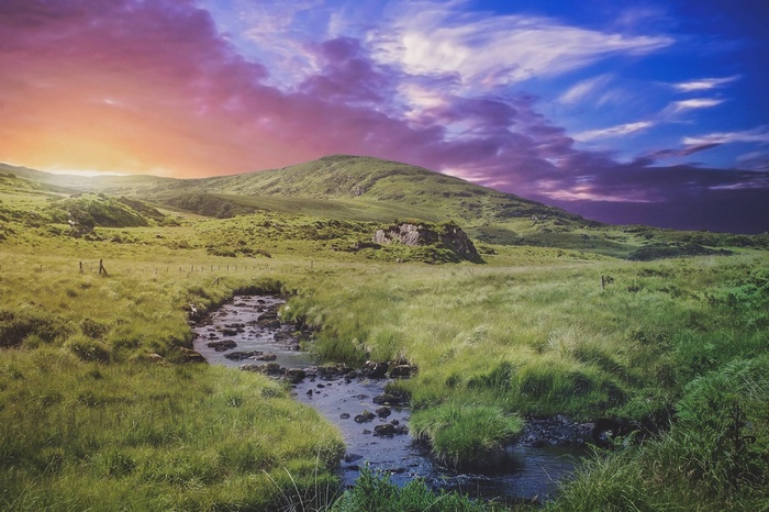 Green hills and stream at twilight in Ireland