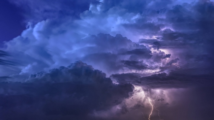 Thunderstorm with lightning flashes in the night sky