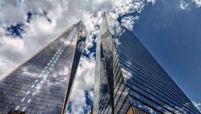 Two skyscrapers in New York City against a cloudy sky