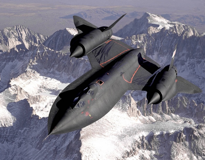 Black SR-71 Blackbird jet flying over snowy mountains
