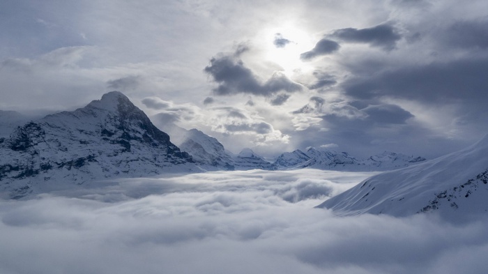 Snowy mountains above clouds in Grindelwald, Switzerland