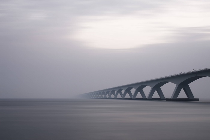 Long concrete bridge with arches over water