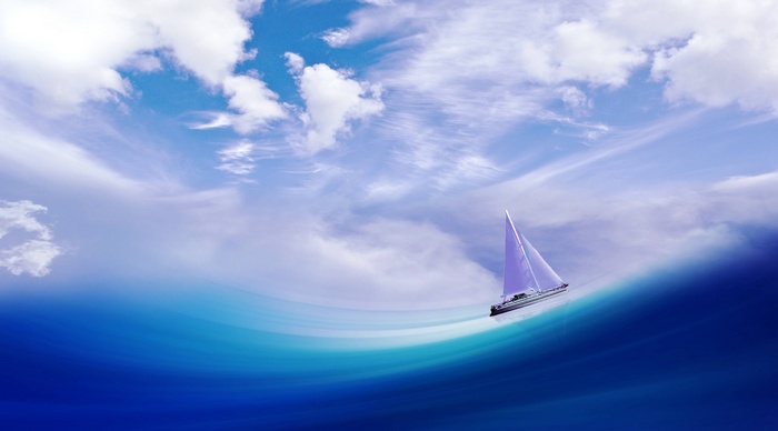 Sailboat on a blue wave under a cloudy sky