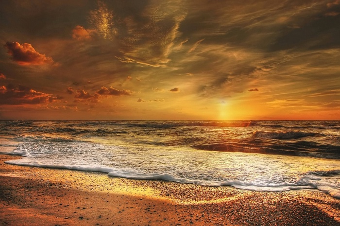 Sunset over the sea on a sandy beach