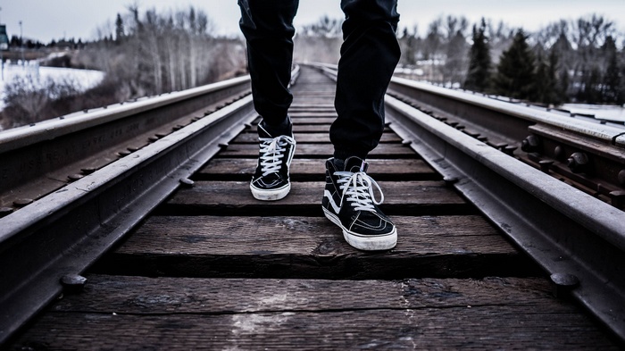 Person walking on railroad tracks