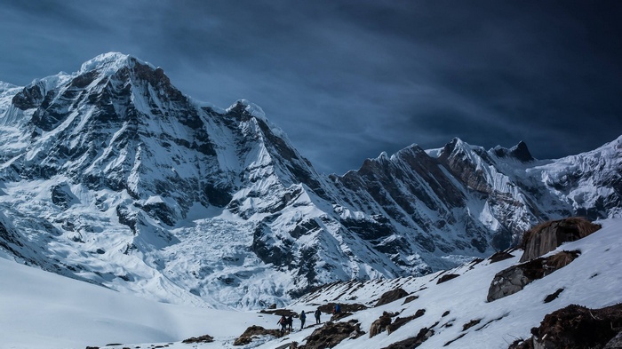 Snowy mountain range with hikers