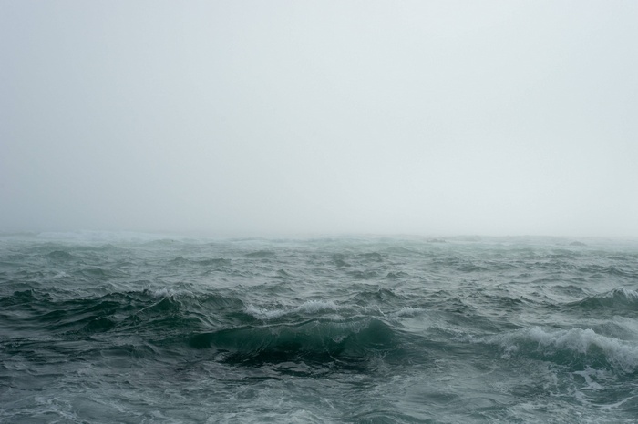 Stormy ocean waves in thick fog