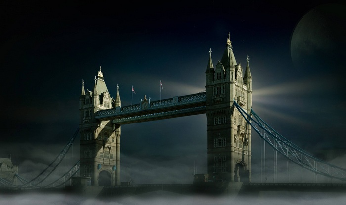Tower Bridge in London at night with a large moon