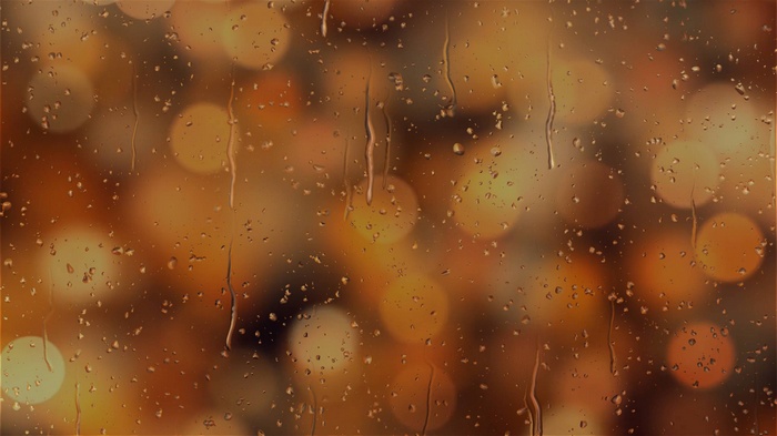 Raindrops on glass with bokeh lights