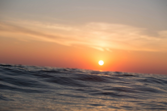 Sunset over the ocean waves
