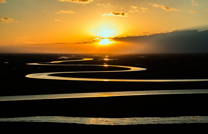 Curved river at sunset