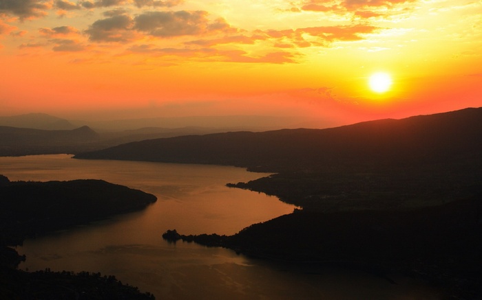 Sunset over a lake and mountains