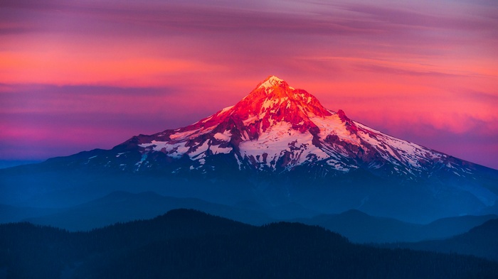 Snow-capped mountain peak at sunset