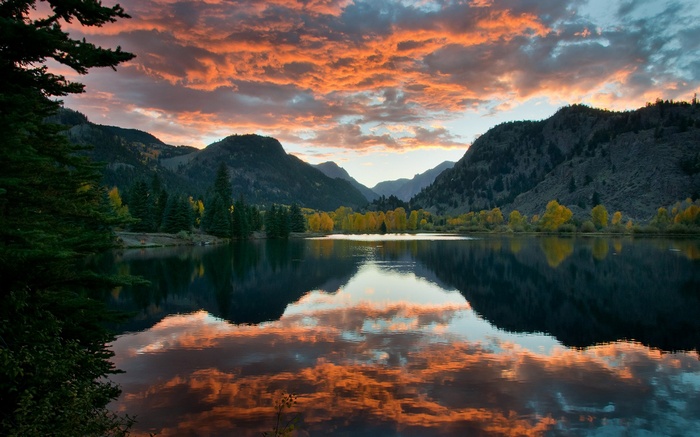 Mountain lake at sunset with colorful clouds