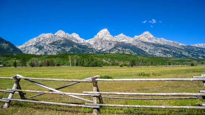 Wooden fence in front of Grand Teton mountains