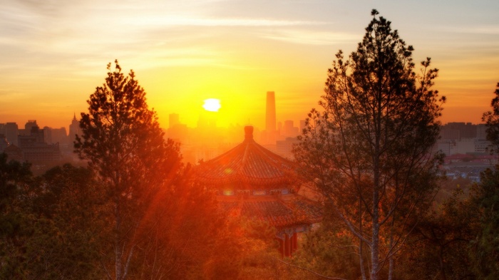 Sunrise over Beijing with traditional temple and modern skyscrapers