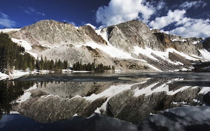 Snow-capped mountains reflected in a calm lake
