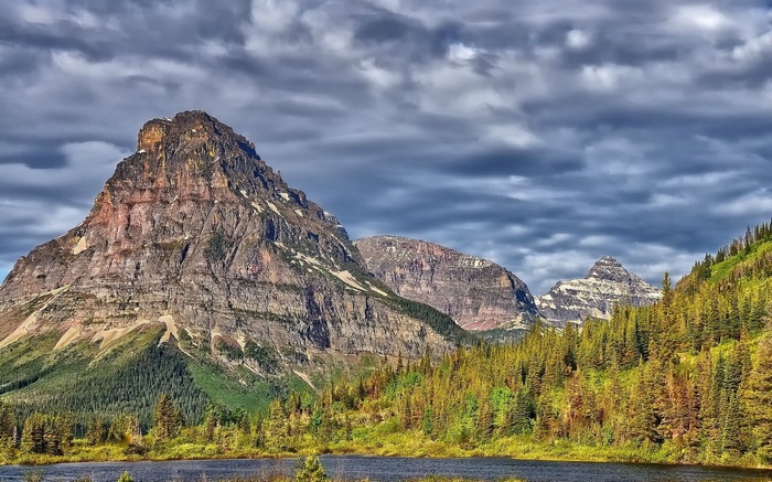 Mountain range with lake and pine forest