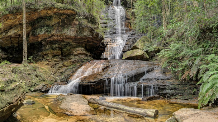 Waterfall cascading over rocks in a forest