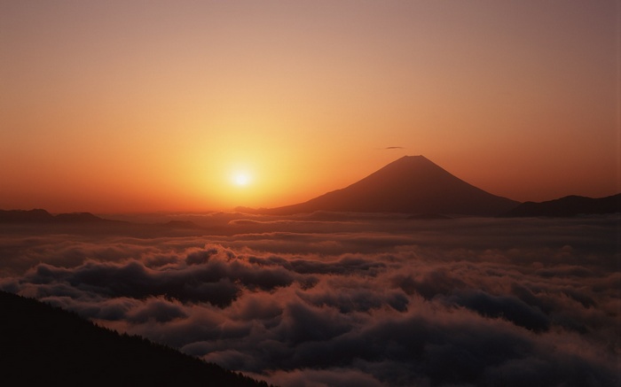 Mount Fuji at sunrise over clouds