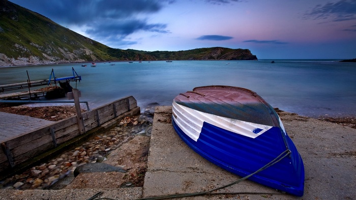 Boat on a rocky shore at dusk