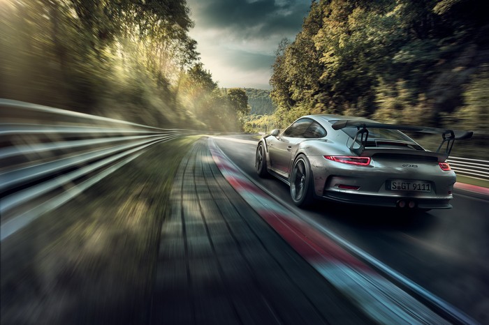 Silver Porsche GT3 RS on a race track