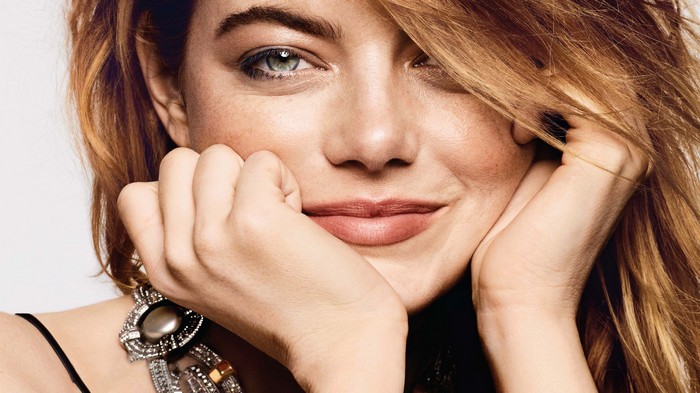Emma Stone close-up portrait with hands on chin